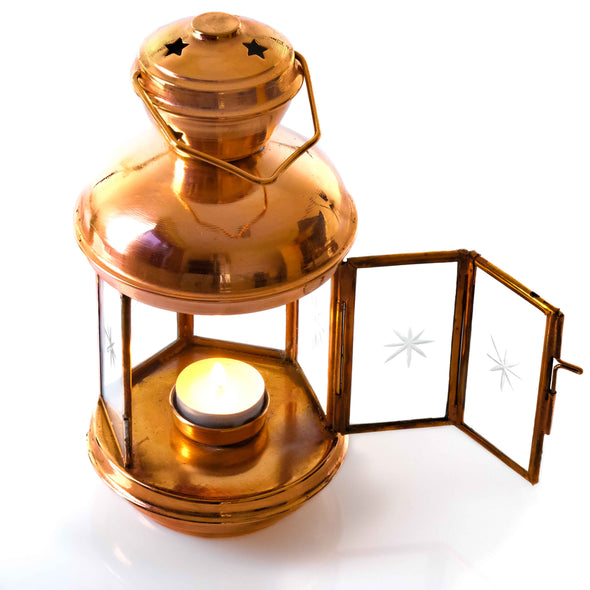 Copper lantern with burning candle croco studios