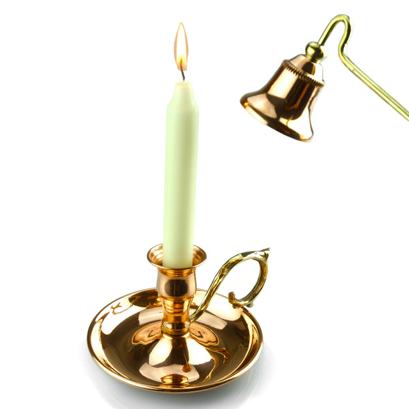 burning candle in copper candlestick holder and copper candle snuffer